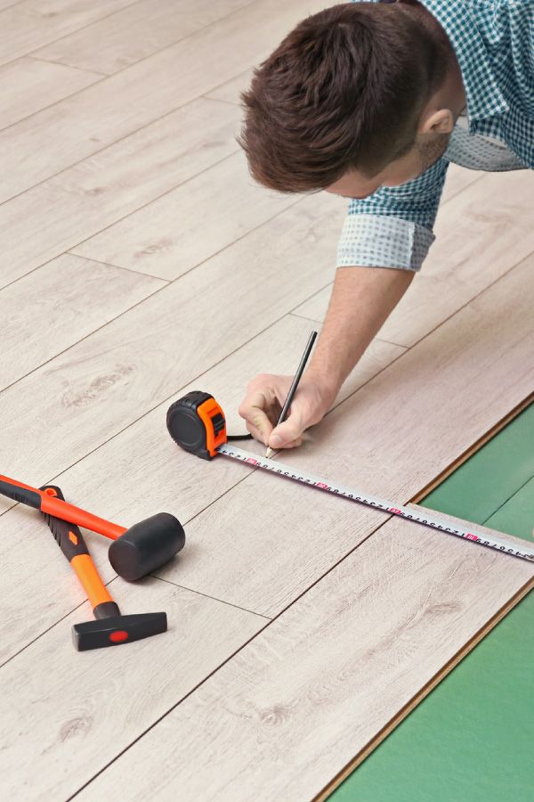 Professional measuring flooring area